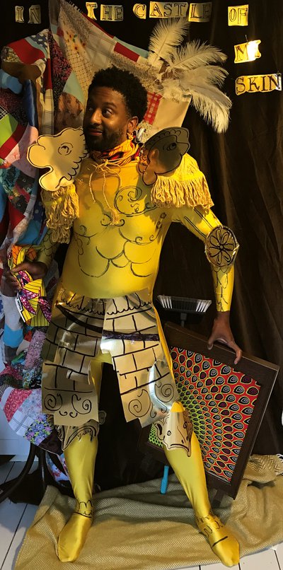 Brathwaite dressed in yellow fabrics with gold-coloured cardboard cut to look like pieces of armour