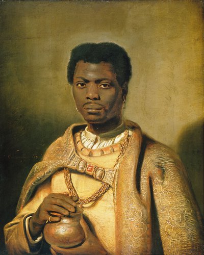 Black man wearing earrings, dressed in rich yellow and gold coloured attire including embroidered cloak and heavy gold chain, clasping a small vase